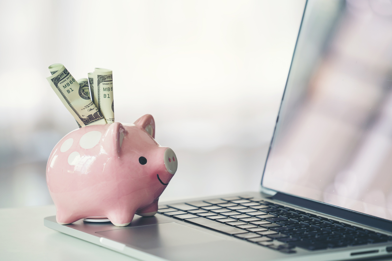 piggy bank with laptop on the desk