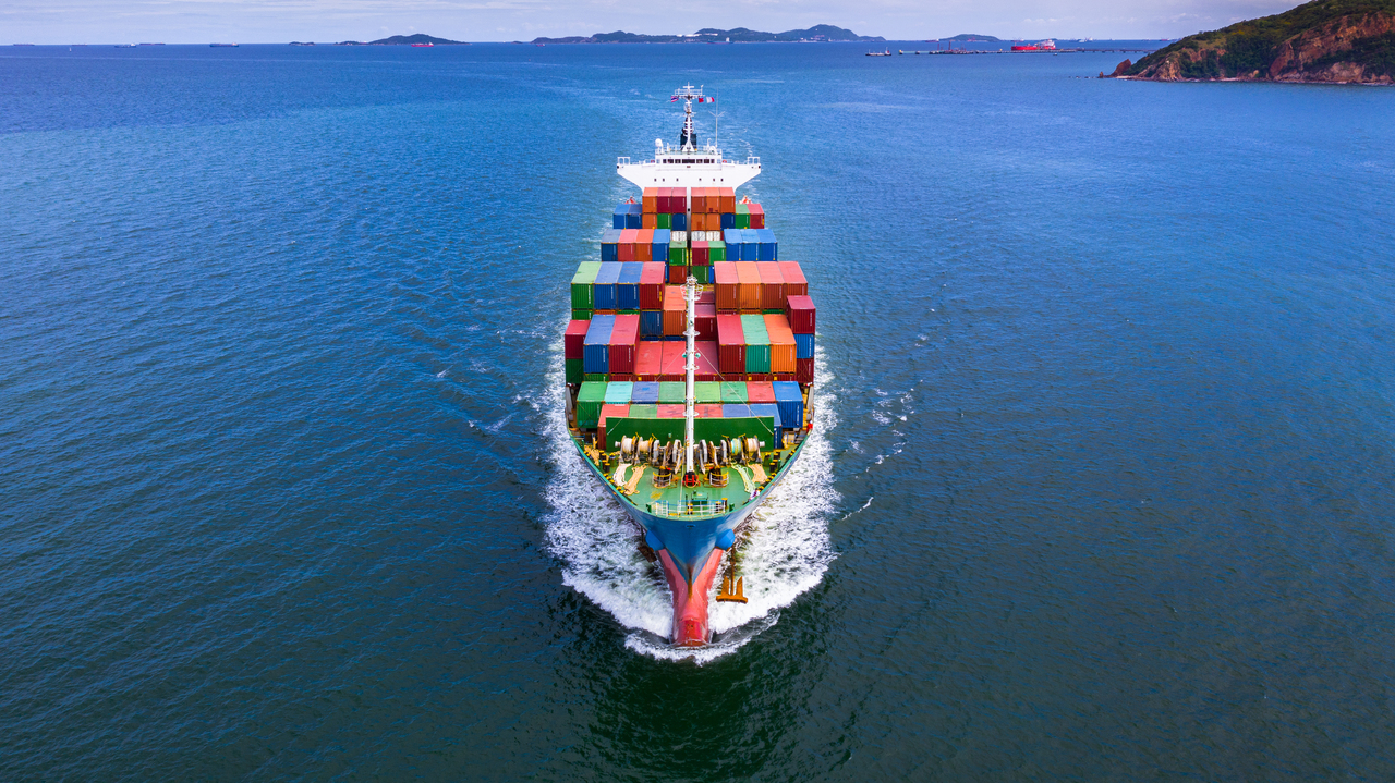 Aerial view container ship carrying container in import export business logistic and transportation of international by container ship in the open sea.