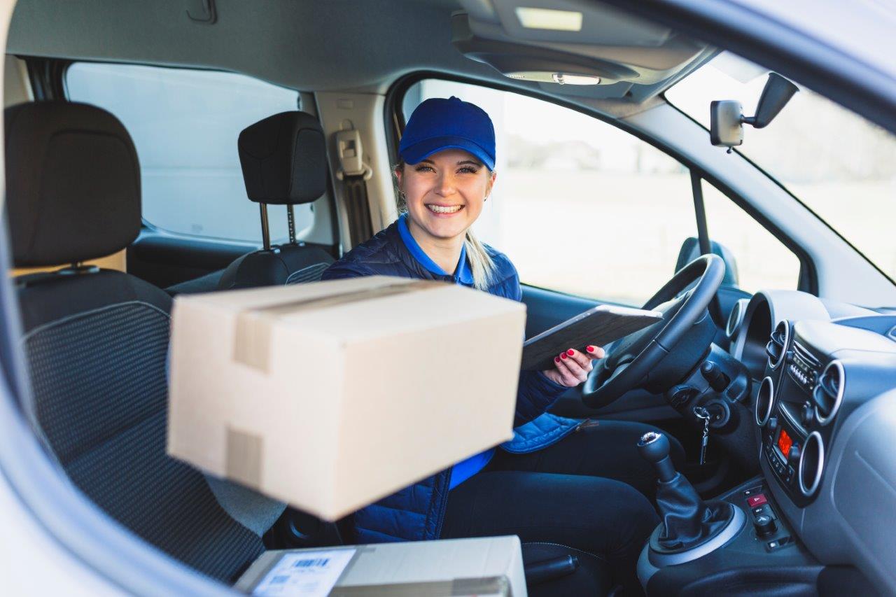 woman in van handing package