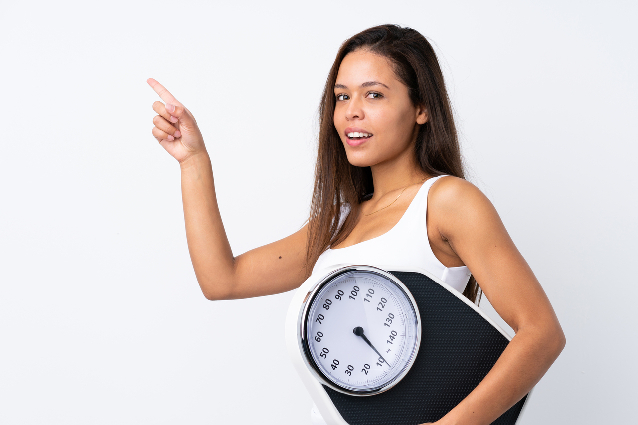 girl holding a scale