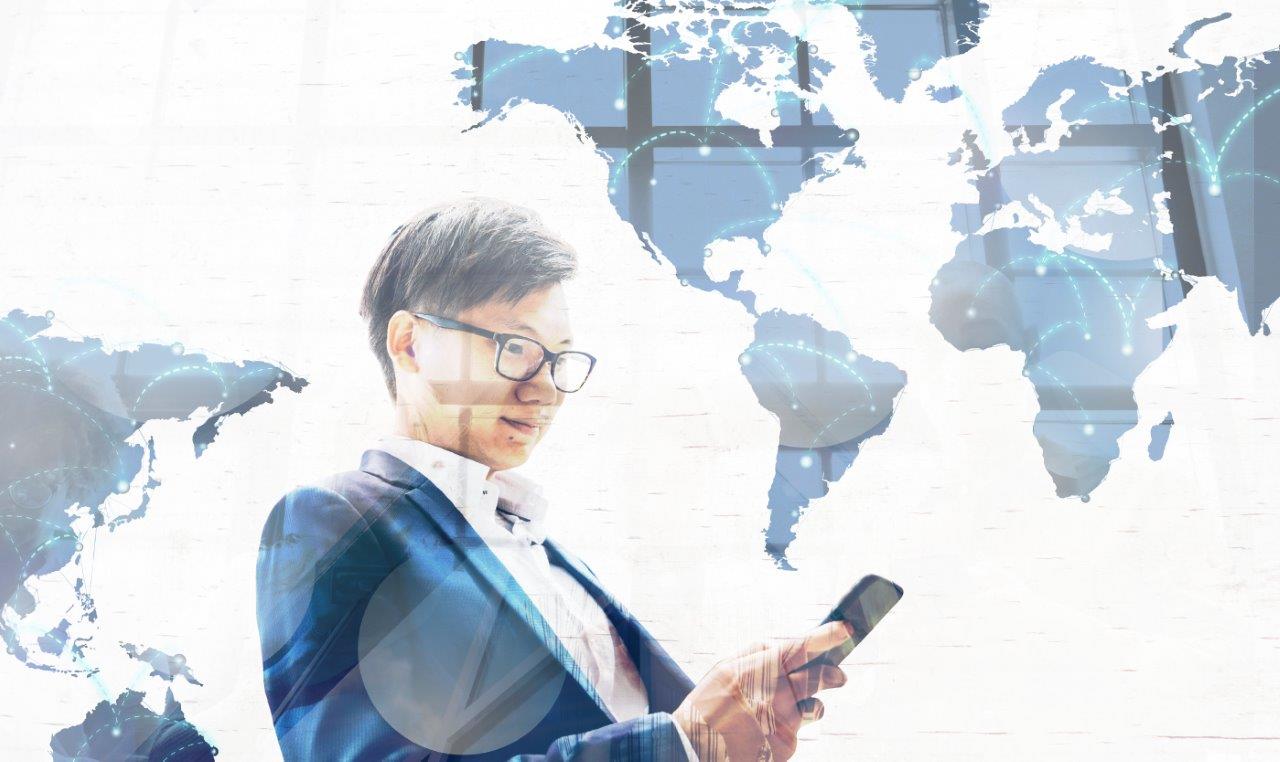 man looking at phone with world map overlay