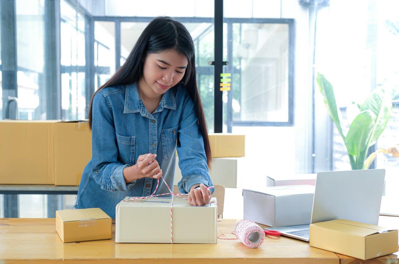 woman tying boxes