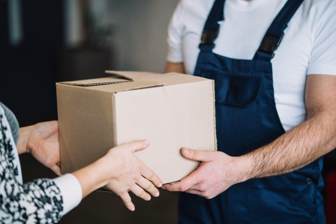 woman receiving delivery man's package