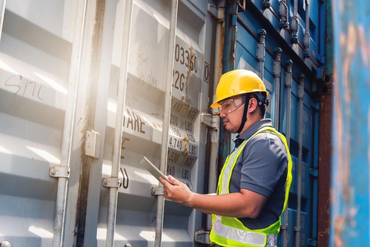 man inspecting container van