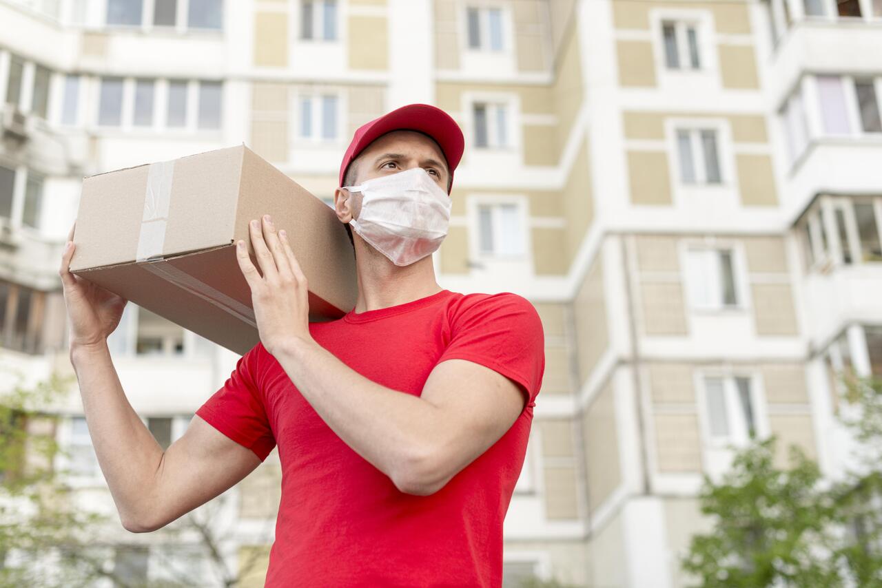A man from a courier service holding a package
