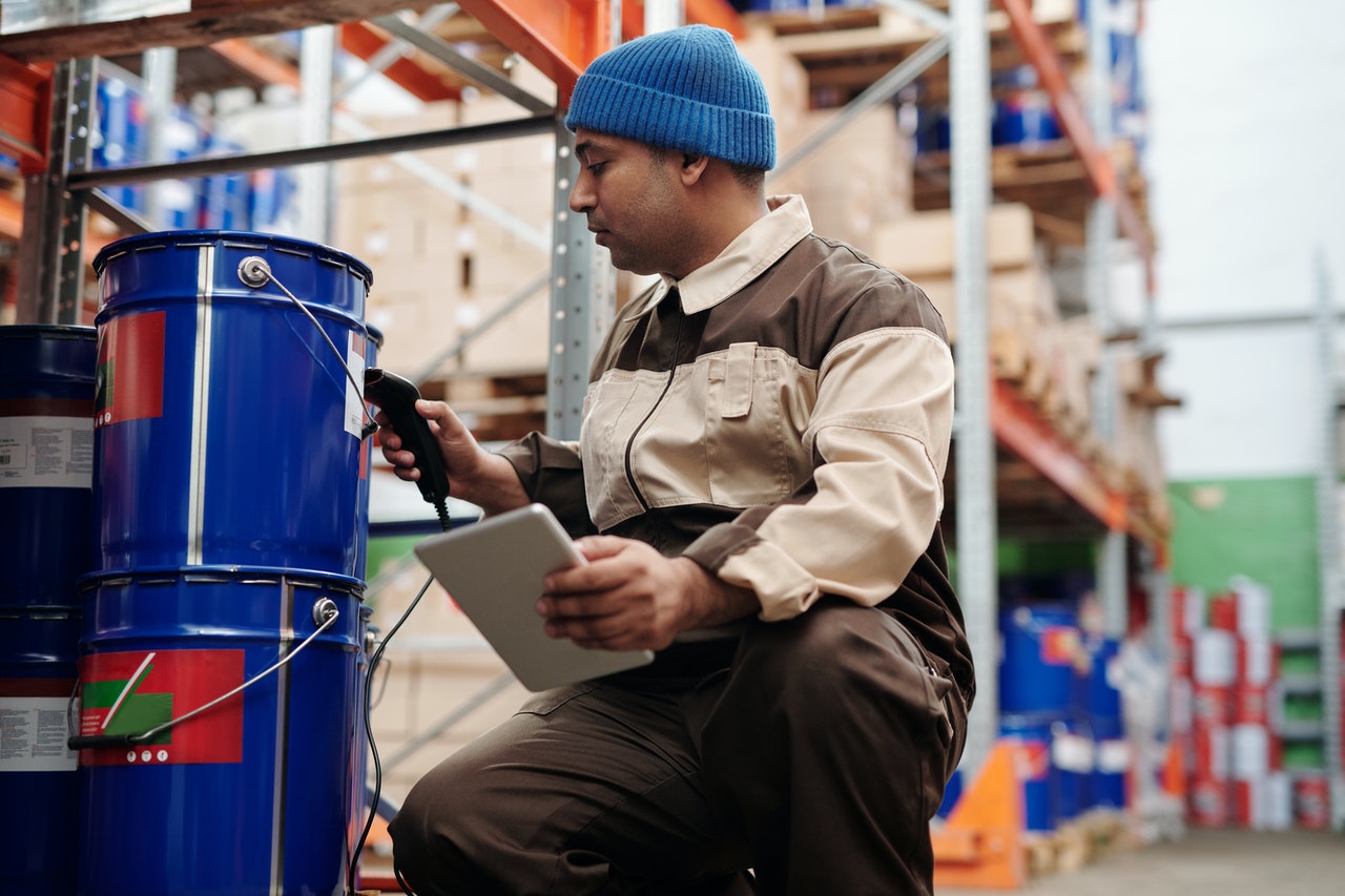 A man using a verification system at a warehouse