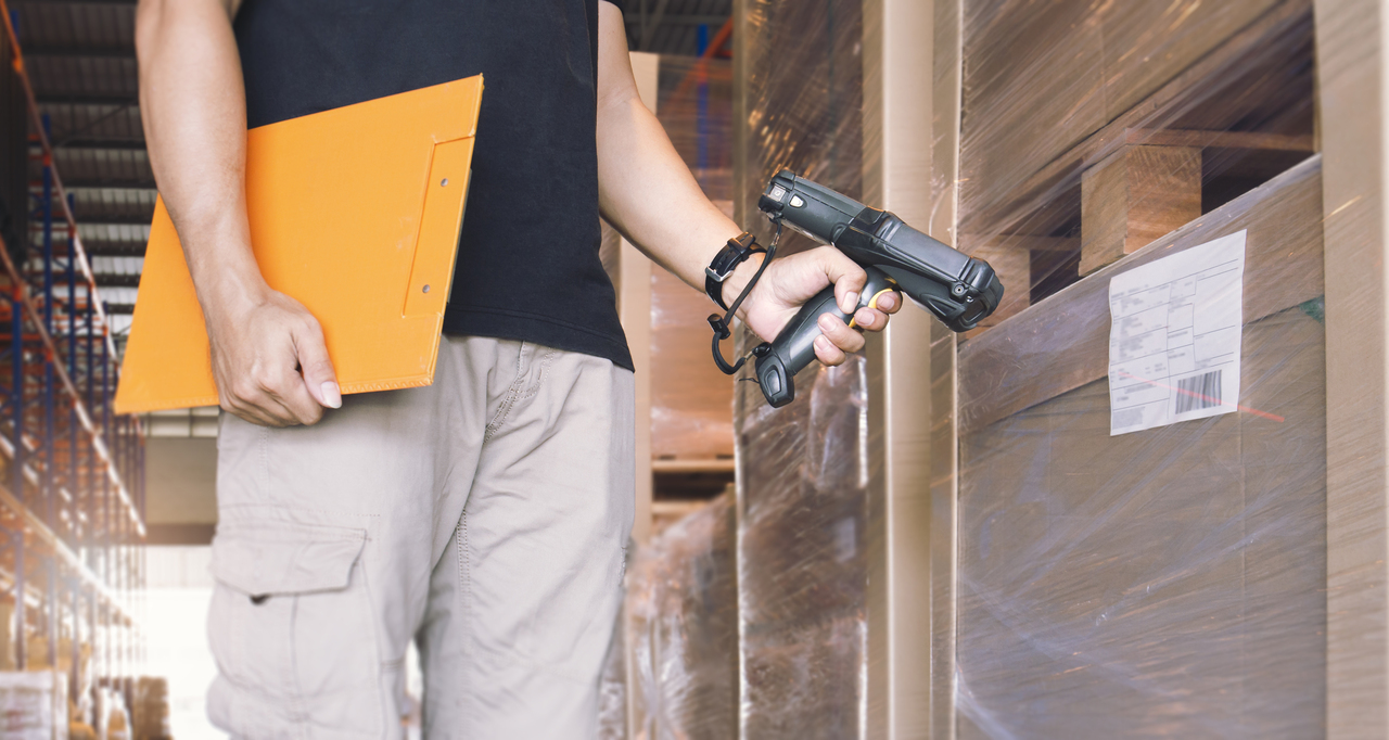 A man scanning a package for a tracking system